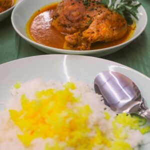 Tantalizing chicken curry with aromatic saffron rice served for a vibrant meal.